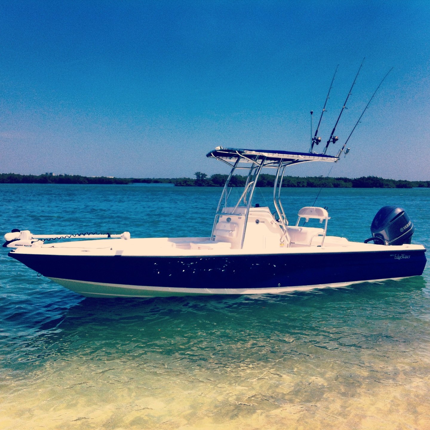 beautiful blue Edgewater boat in shallow water
