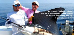 two people in a boat holding a large sailfish