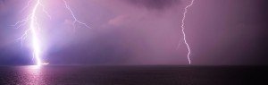bright lightning against a purple sky
