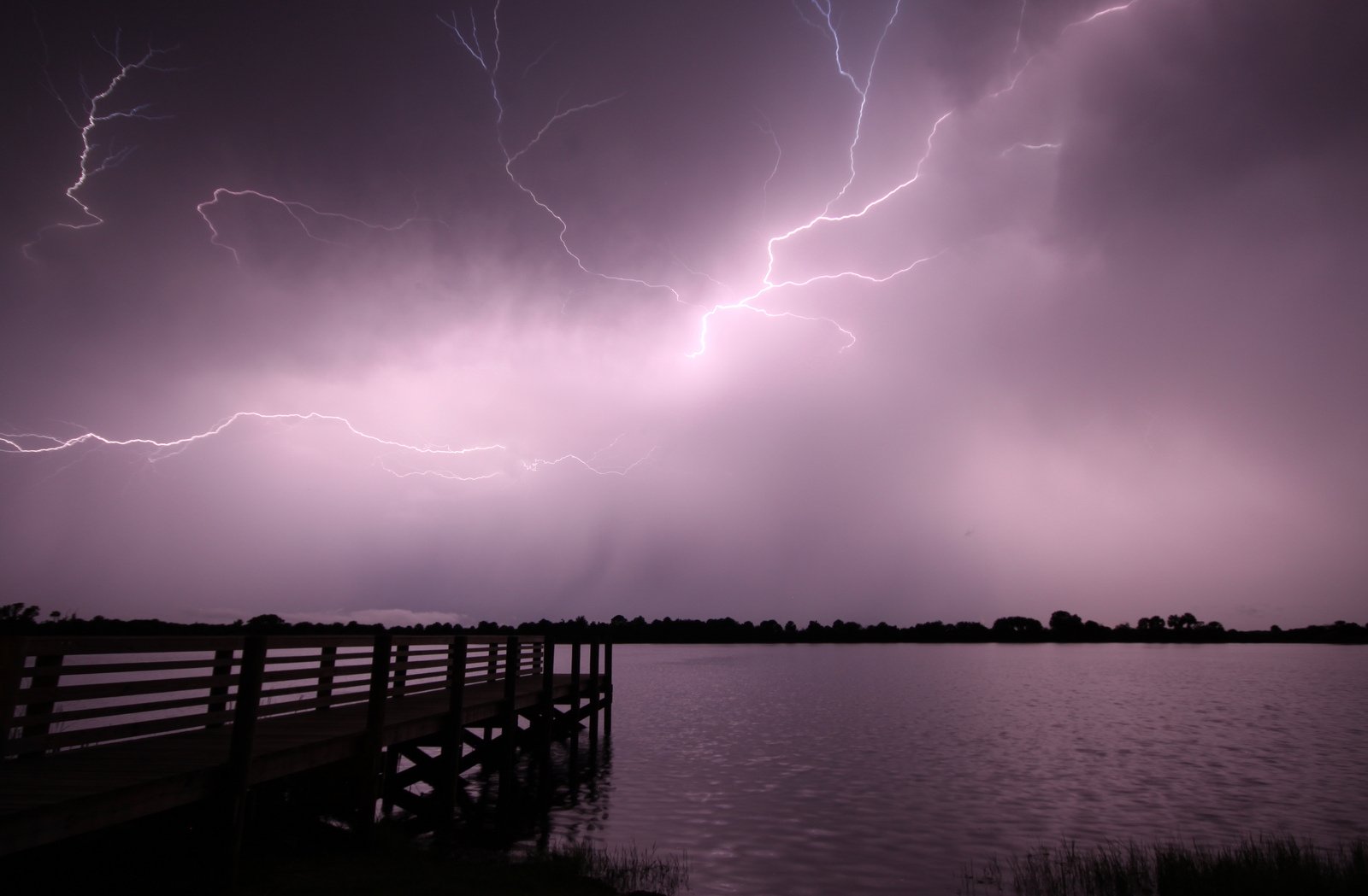bright lightning over a lake and dock