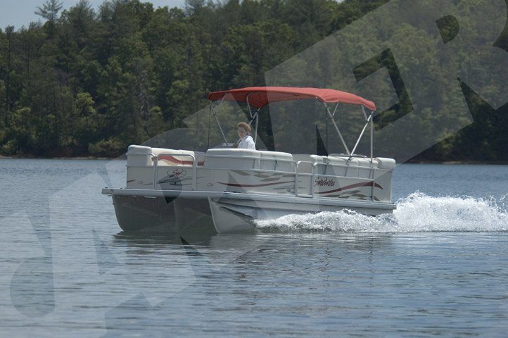 pontoon boat on the lake with a red bimini top