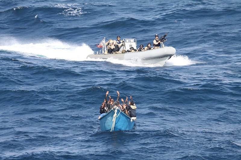 U.S. coast guard in an inflatable boat arresting a boat of pirates