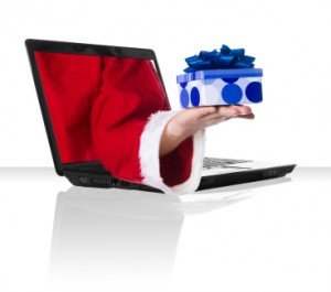 black laptop with Santa holding a present wrapped in blue