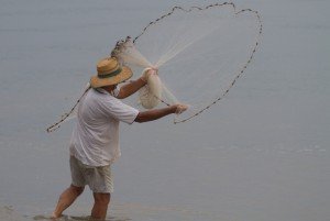 man throwing a casting net
