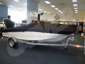 white boston whaler boat with a black boat cover