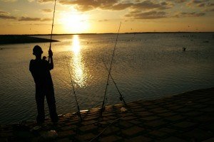 Guy fishing at sunset