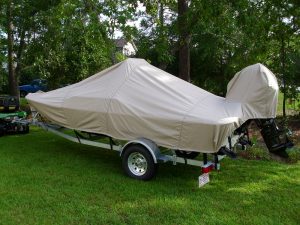 Rear View of a trailered Carolina Skiff JV 17 CC with a beige Carver Performance Poly-Guard boat cover